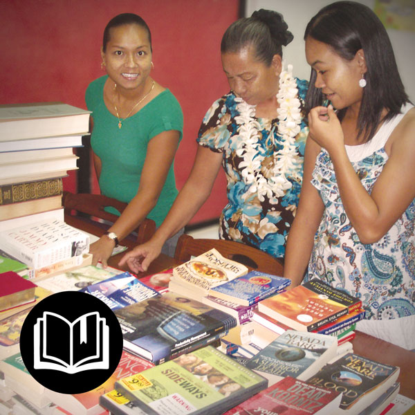 Local women sampling the donated books at the library in Rota