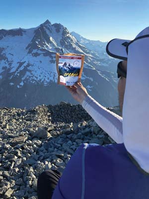 Nic holding an Outpost Pouch up in front of Mount Shuksan